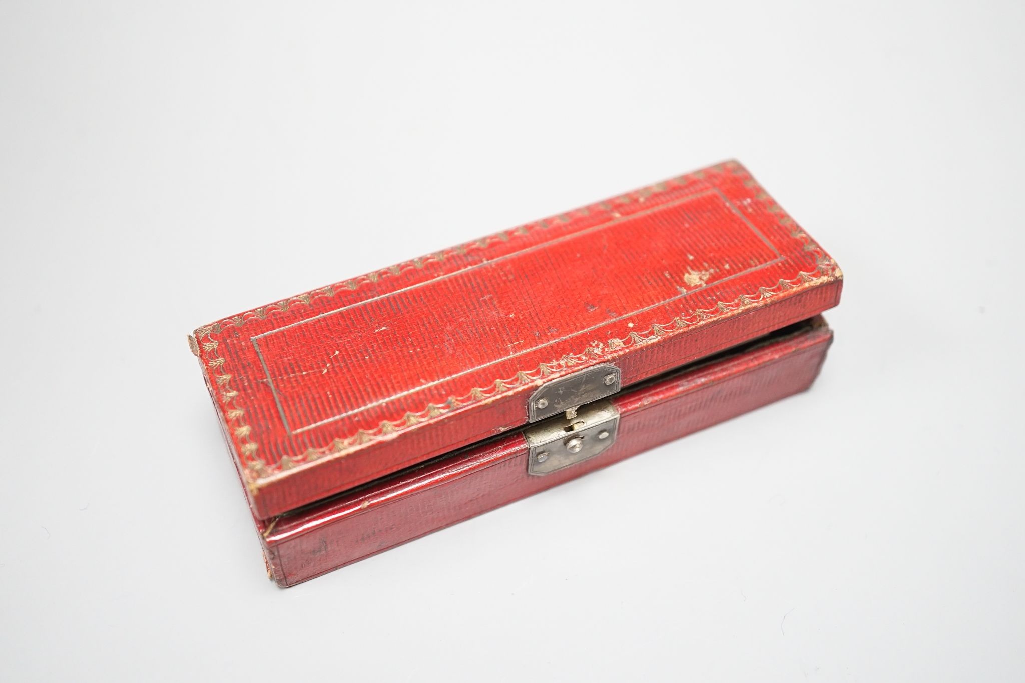 A 19th century Ostenberg morocco leather cased set of three cut throat razors with topographical etched blades, case 10.5cm